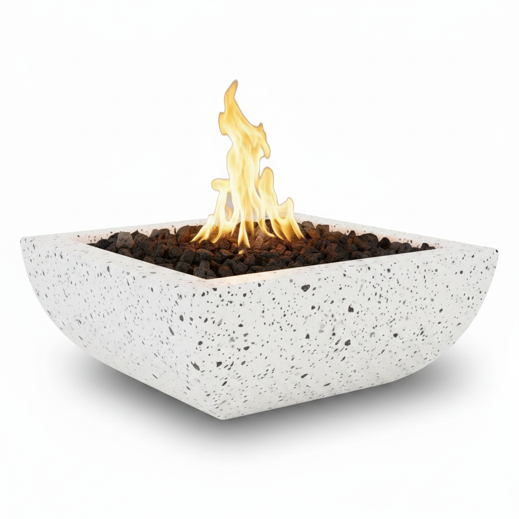 A square concrete fire pit with a speckled white finish, filled with dark lava rocks and lit with a bright yellow and orange flame, set against a plain white background.