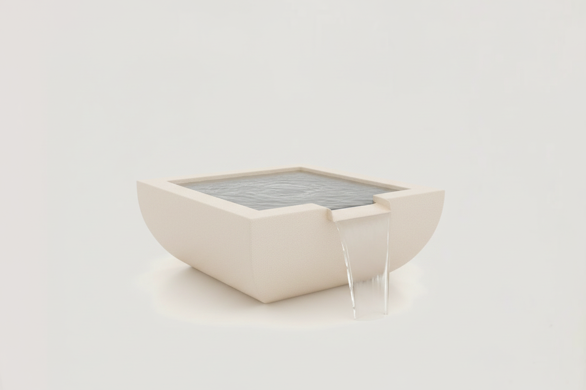 A minimalist square concrete water fountain with a shallow gray water basin and a small waterfall spout, shown on a clean off-white background.