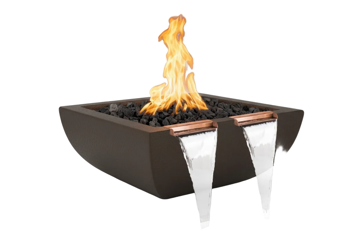 A modern square fire pit with a dark brown exterior, black stones, a bright orange flame, and two clear waterfall spouts with copper-colored trim, shown on a light gray background.