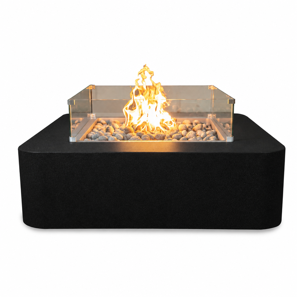 A modern black rectangular fire pit table with a clear acrylic wind guard, filled with gray river rocks and a bright orange-yellow flame, shown against a solid white background.