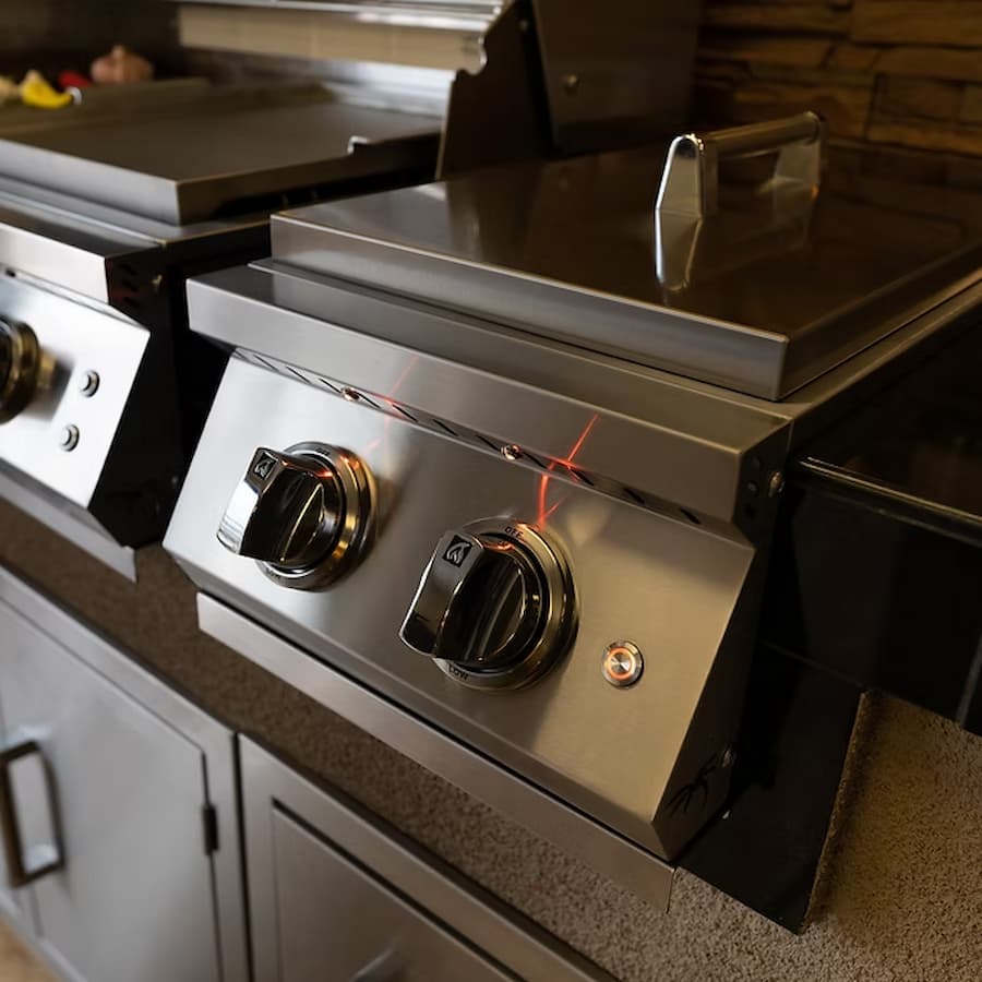 Stainless steel stove with control knobs in a kitchen setting