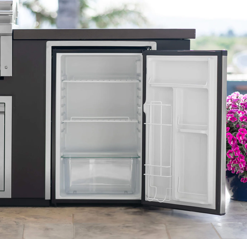 Small refrigerator with open door in a kitchen setting