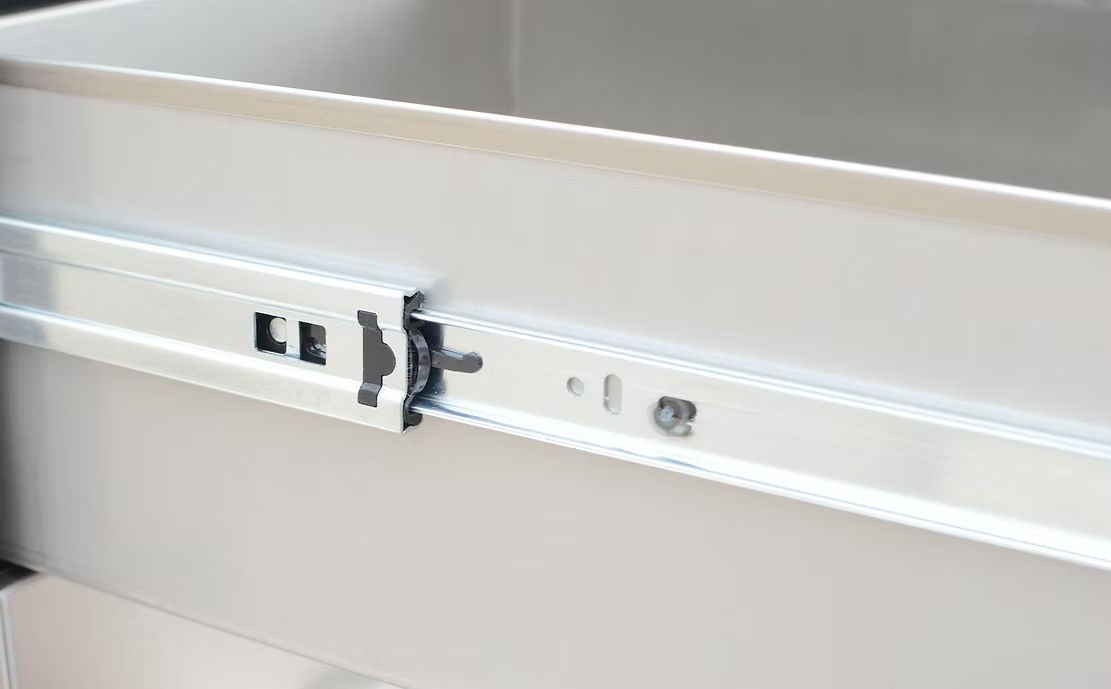 Metal drawer slide mechanism on a white background
