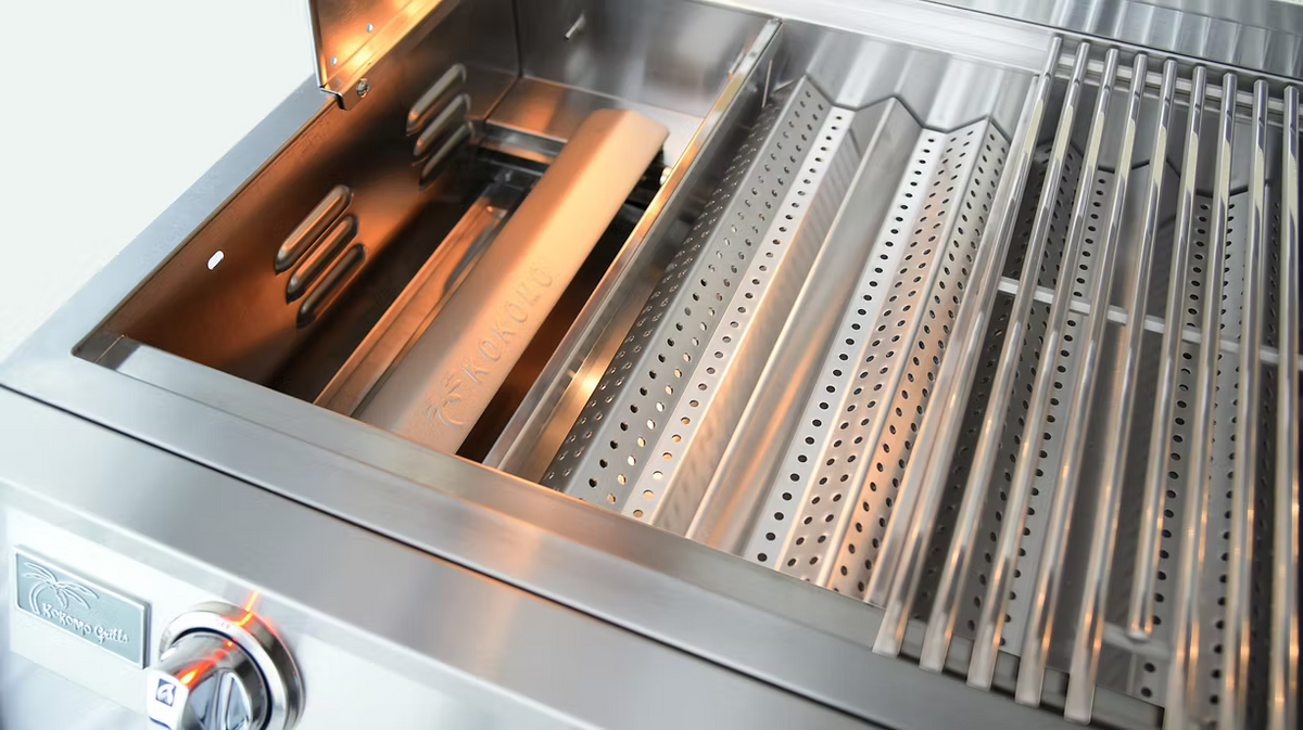 Stainless steel grill with various components on a light gray background