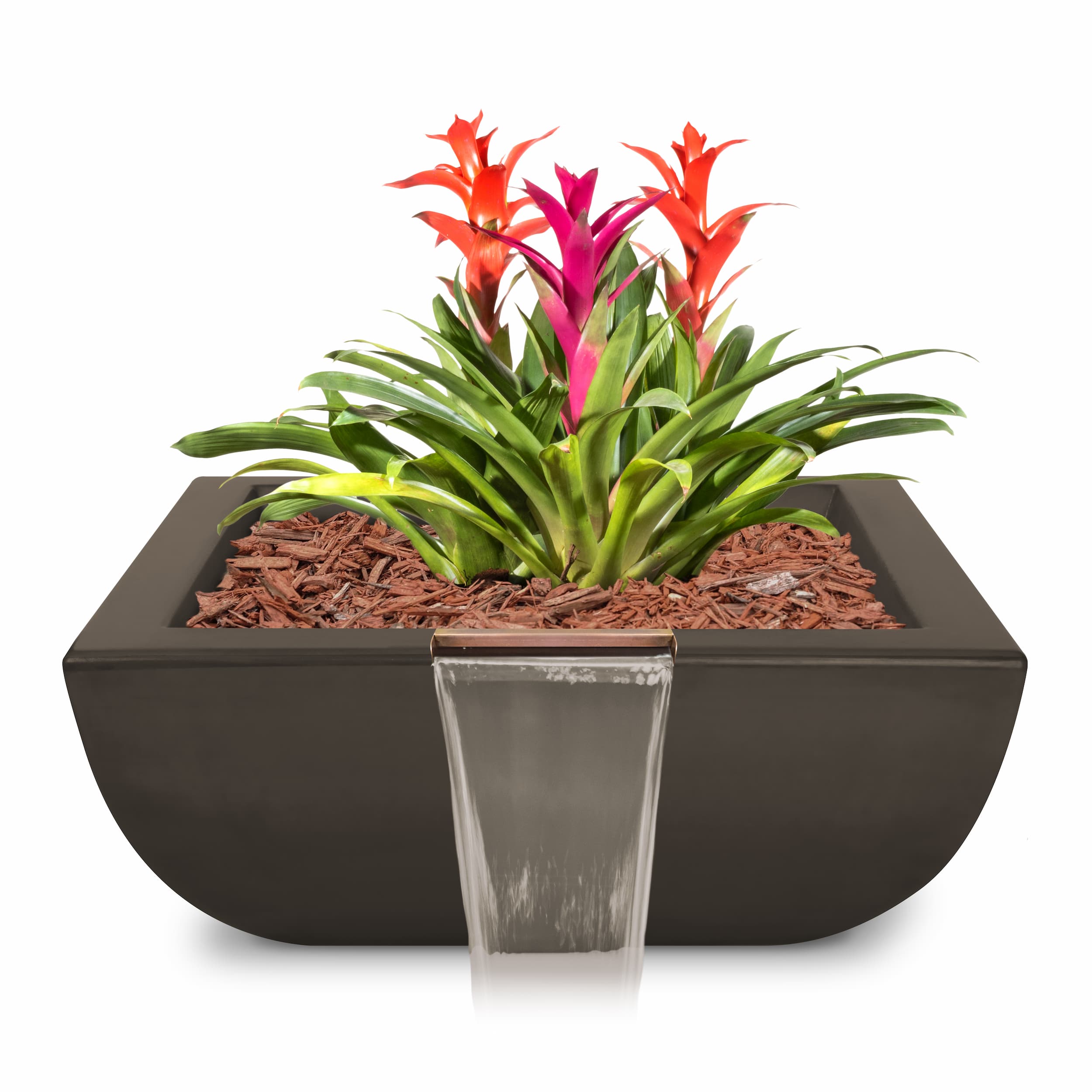 A modern rectangular planter with a small front waterfall feature, filled with brown wood chips and planted with green foliage and bright red and pink flowers, shown on a white background.