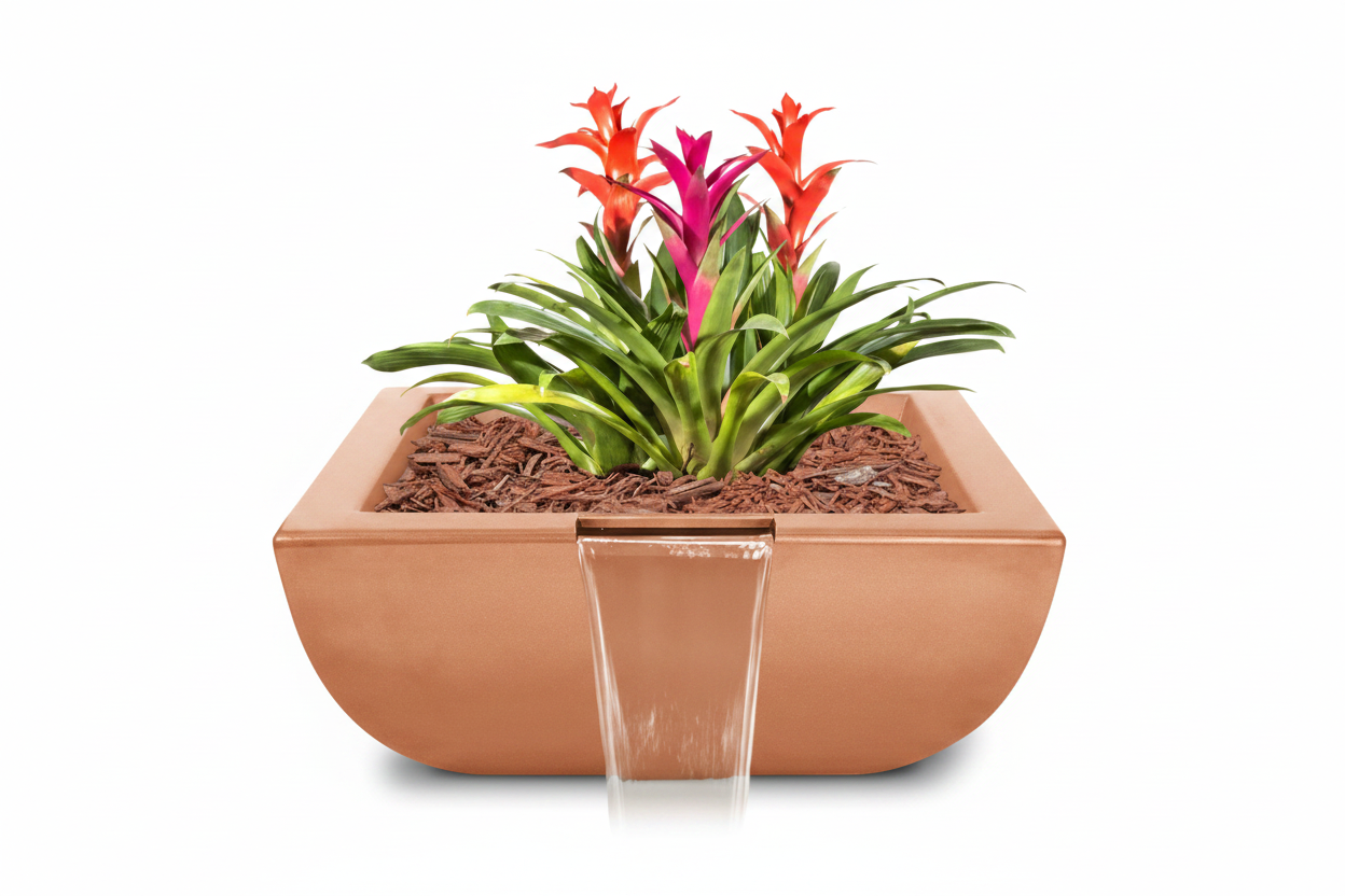 A rectangular copper planter with a waterfall spout, filled with soil, mulch, and a green plant with bright orange and pink flowers, isolated on a white background.