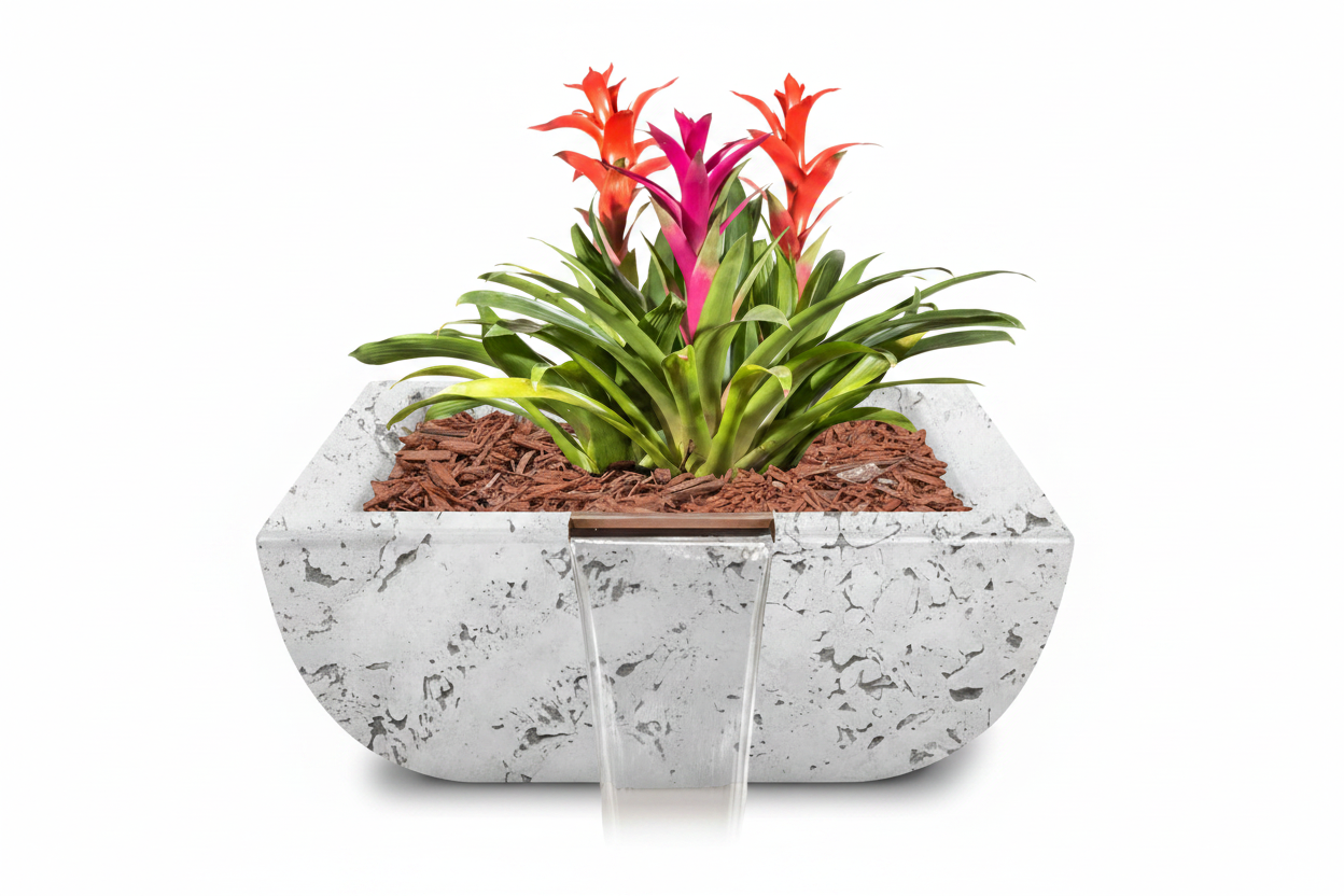 A rectangular concrete planter with a small front waterfall feature, filled with brown mulch and green plants featuring bright orange and magenta flowers, set against a solid white background.