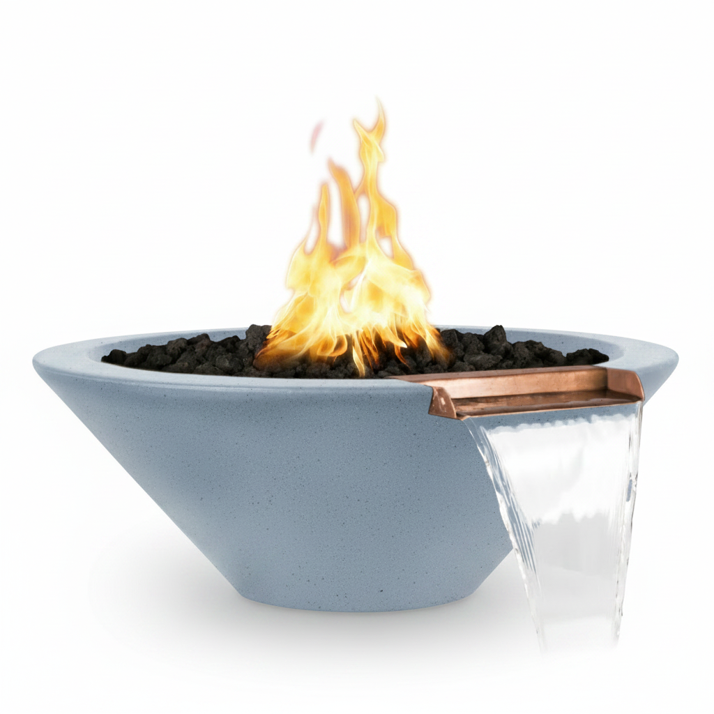 A modern outdoor fire pit bowl in a light blue-gray finish, featuring a copper-colored spout with a clear waterfall effect, filled with black fire rocks and active orange and yellow flames, set against a solid white background.