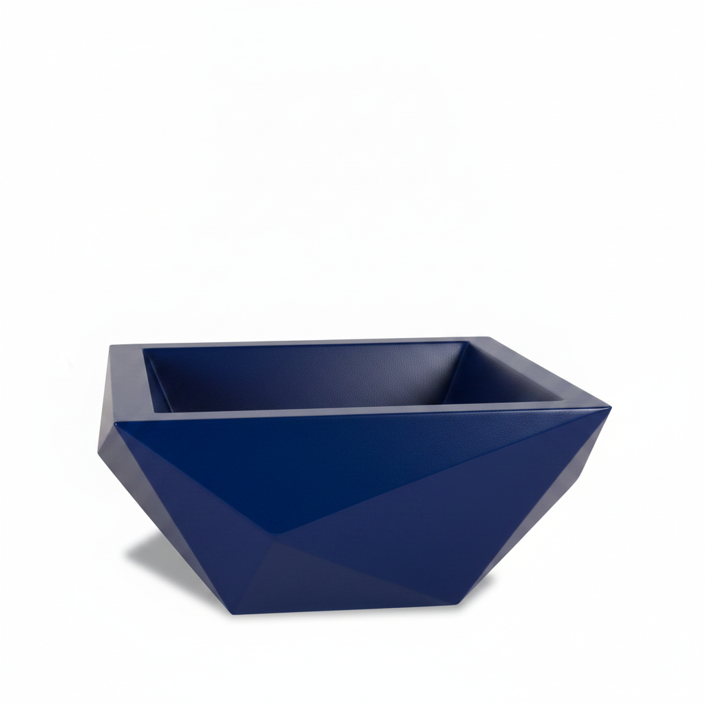 A modern geometric rectangular planter pot in a deep navy blue color, featuring faceted polygonal sides and a wide open top, shown on a clean white background.