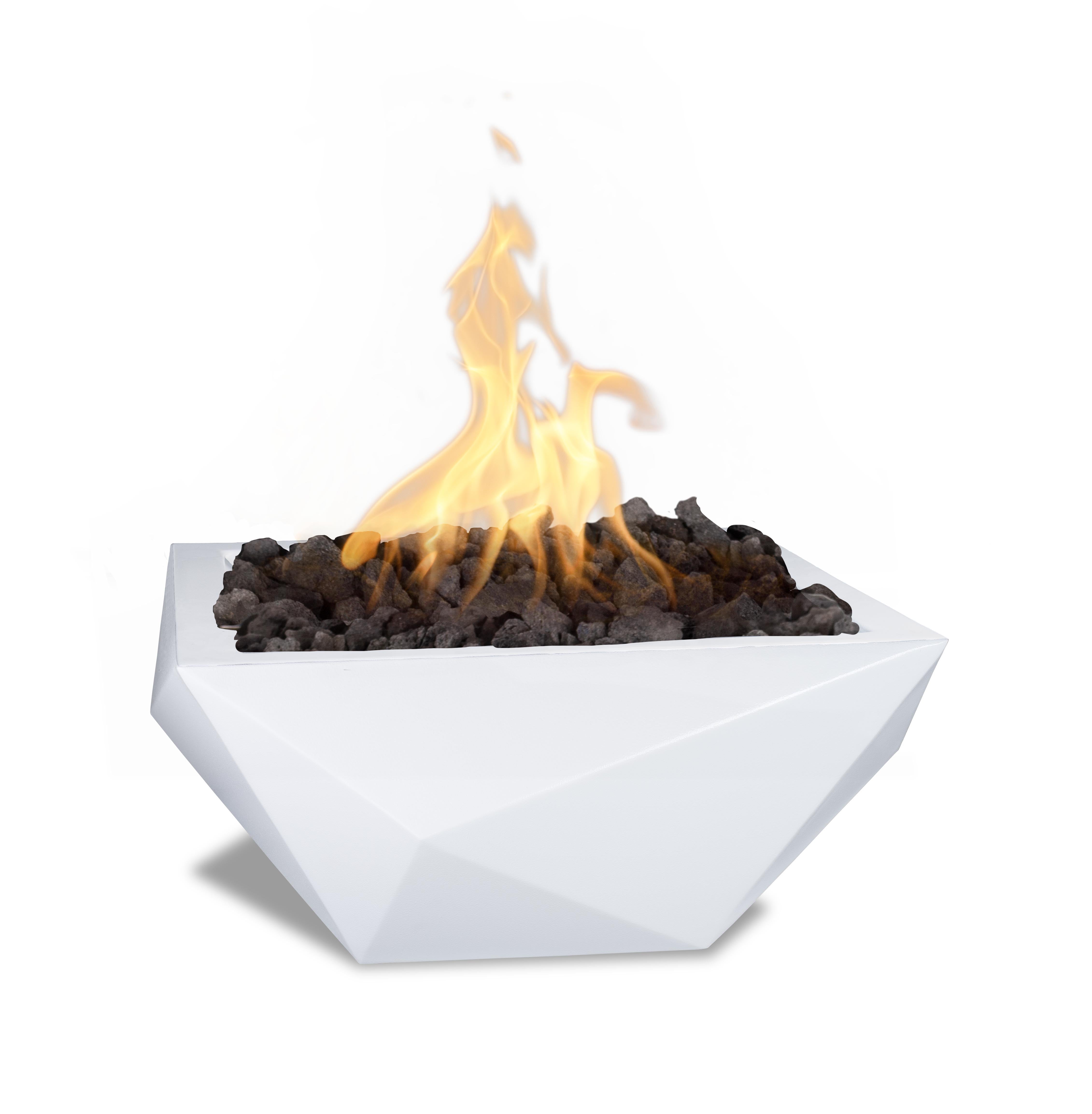 A modern white geometric fire pit planter filled with dark charcoal stones and active orange and yellow flames, isolated on a white background.