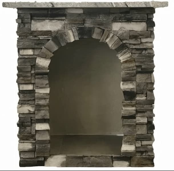 A stone fireplace mantel or niche surround with a stacked slate look, featuring a central arched opening and a flat top surface, shown against a plain white background.
