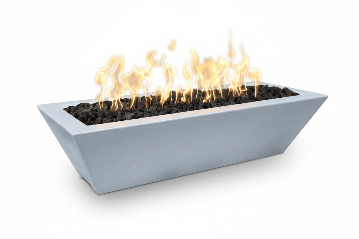A modern rectangular outdoor fire pit with a light gray concrete-look body, black stones, and active orange and yellow flames, shown on a white background.