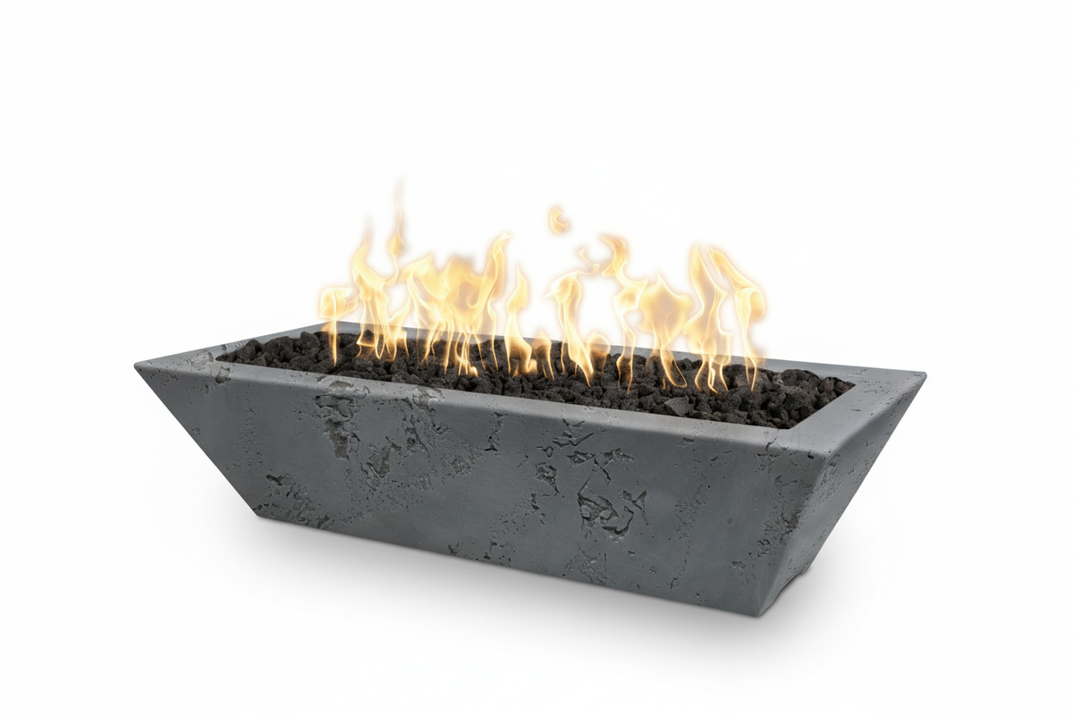 A rectangular concrete fire pit with a modern tapered design, filled with dark river rocks and active orange and yellow flames, shown on a solid white background.