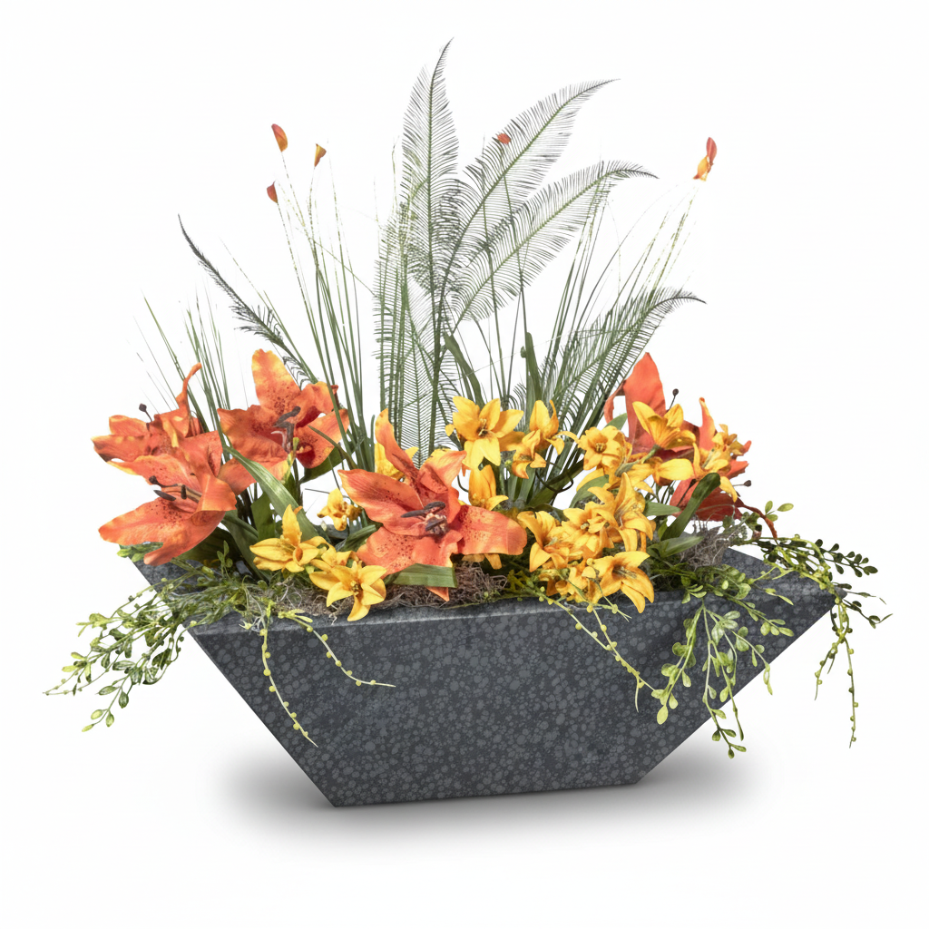 A modern geometric dark gray planter filled with a dense arrangement of orange lilies, yellow flowers, and green ornamental grasses, shown on a white background.