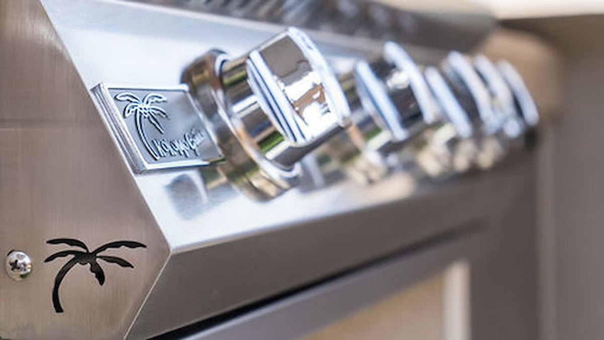 Close-up of a metallic control panel with palm tree designs on a blurred background