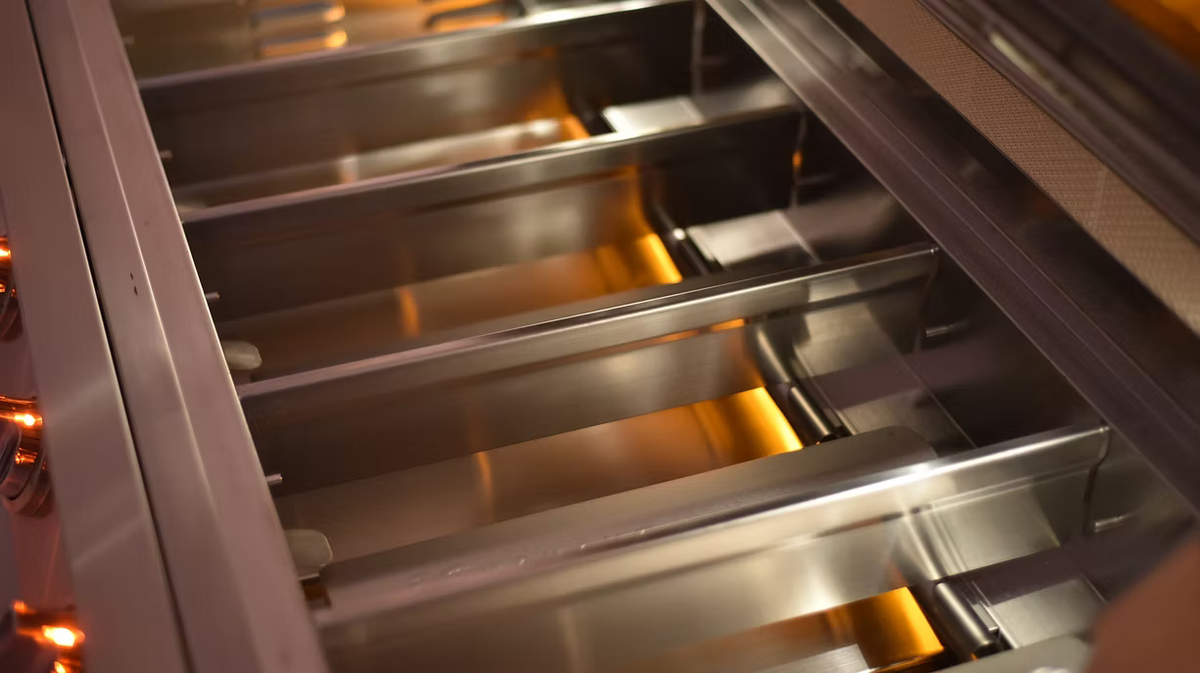 Close-up of a metallic oven rack with a blurred background