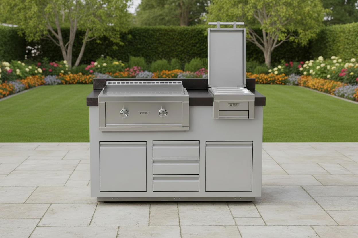A stainless steel outdoor kitchen island set with a built-in grill, drawer units, and a tall vertical storage cabinet, shown on a paved patio with a landscaped garden background.