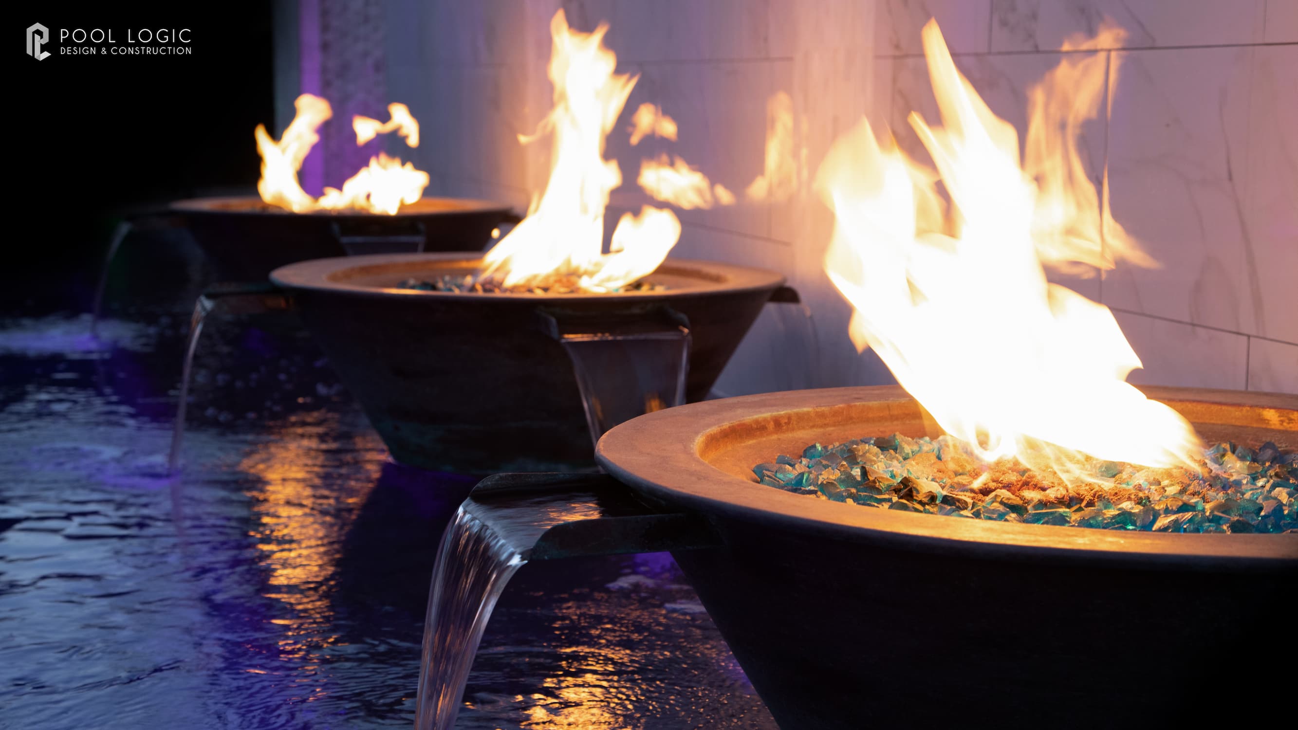 Fire bowls with flames in a pool setting, featuring the Pool Logic logo.