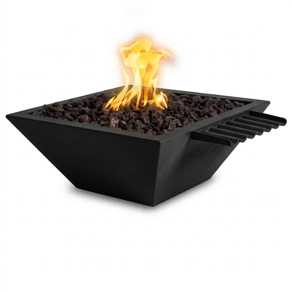 A modern square black fire pit with a glowing orange and yellow flame, filled with dark decorative stones, shown on a solid white background.