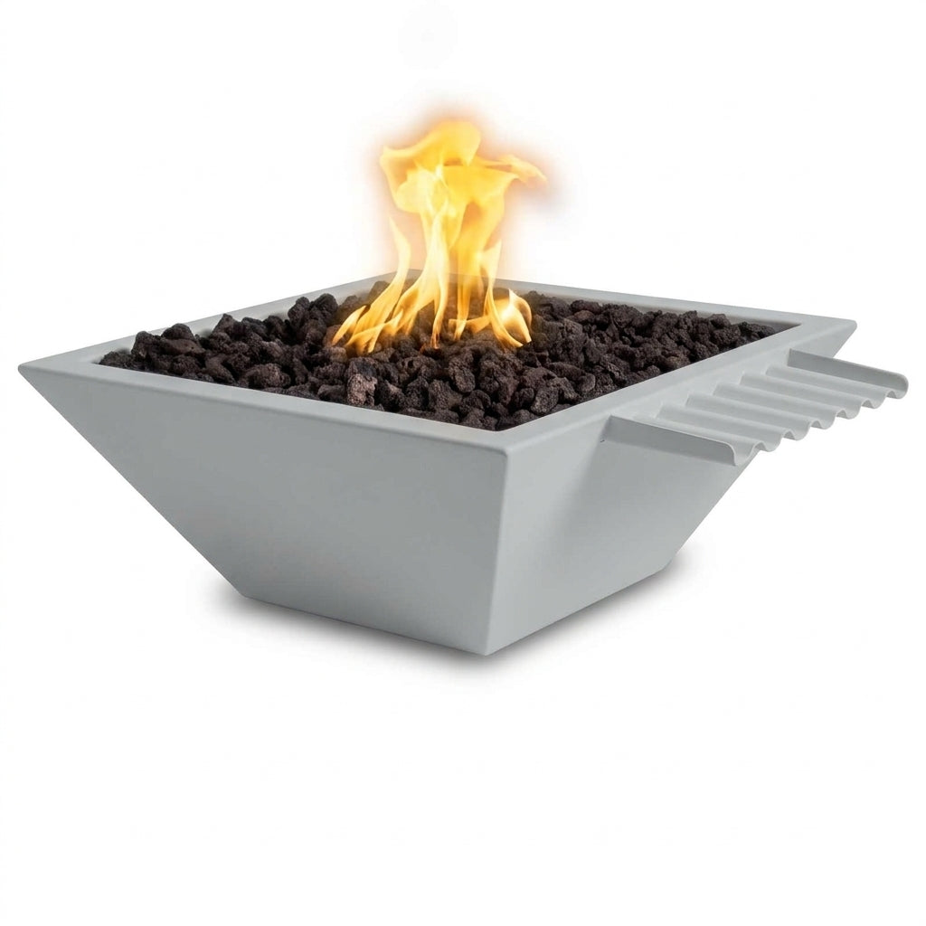 A square gray outdoor fire pit bowl filled with dark lava rocks and lit with a bright orange flame, shown on a clean white background.