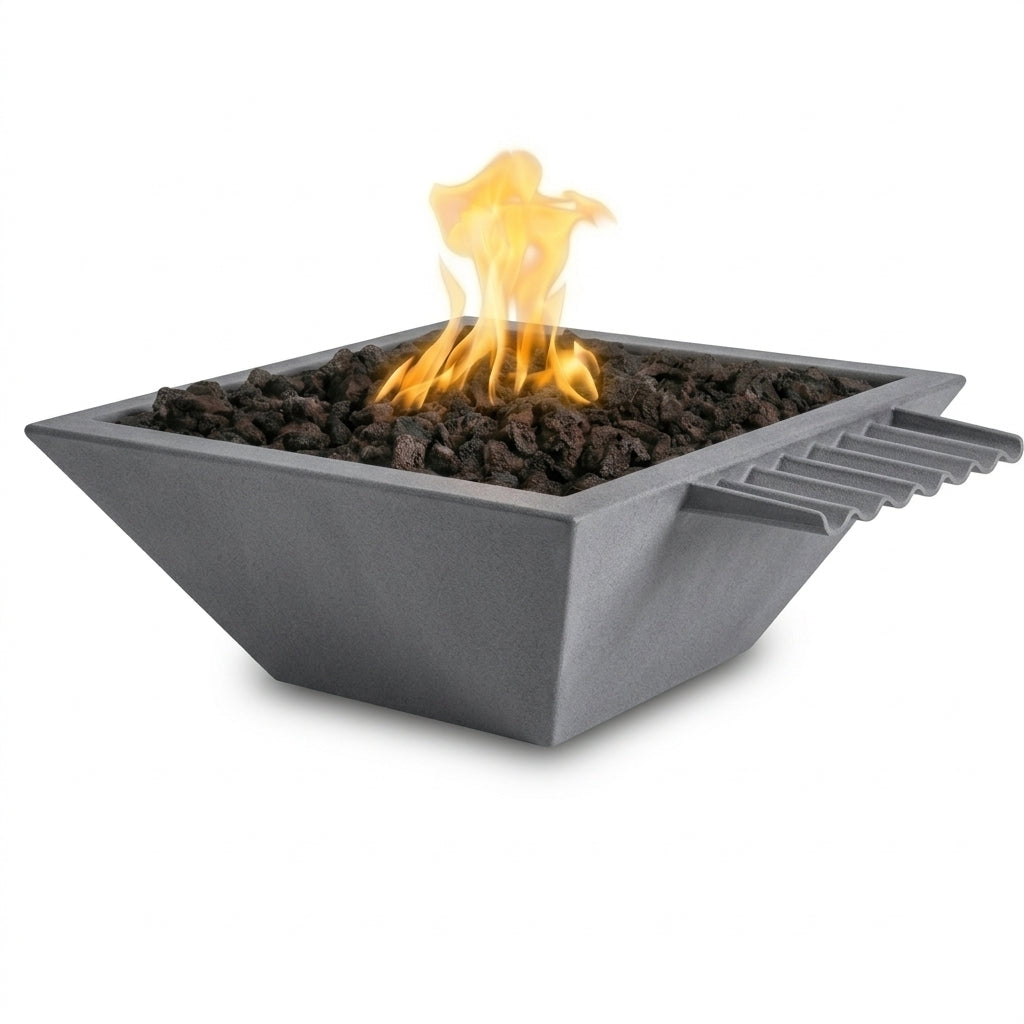 A square gray outdoor fire pit filled with dark charcoal stones and lit with a bright yellow-orange flame, shown on a clean white background.